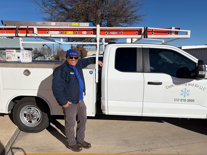 Michael Cook, owner of Cook Heating and Air, standing next to his service truck in Georgetown, TX