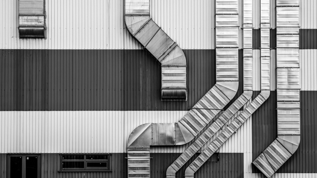 Metal ducts on striped wall