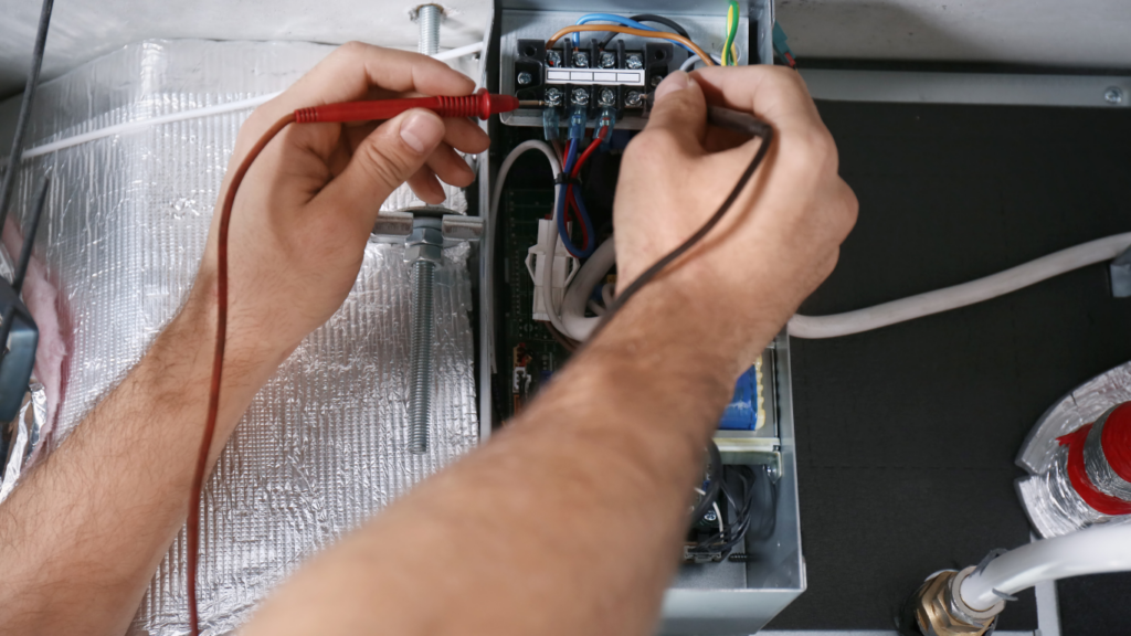 Hands working on electrical connections