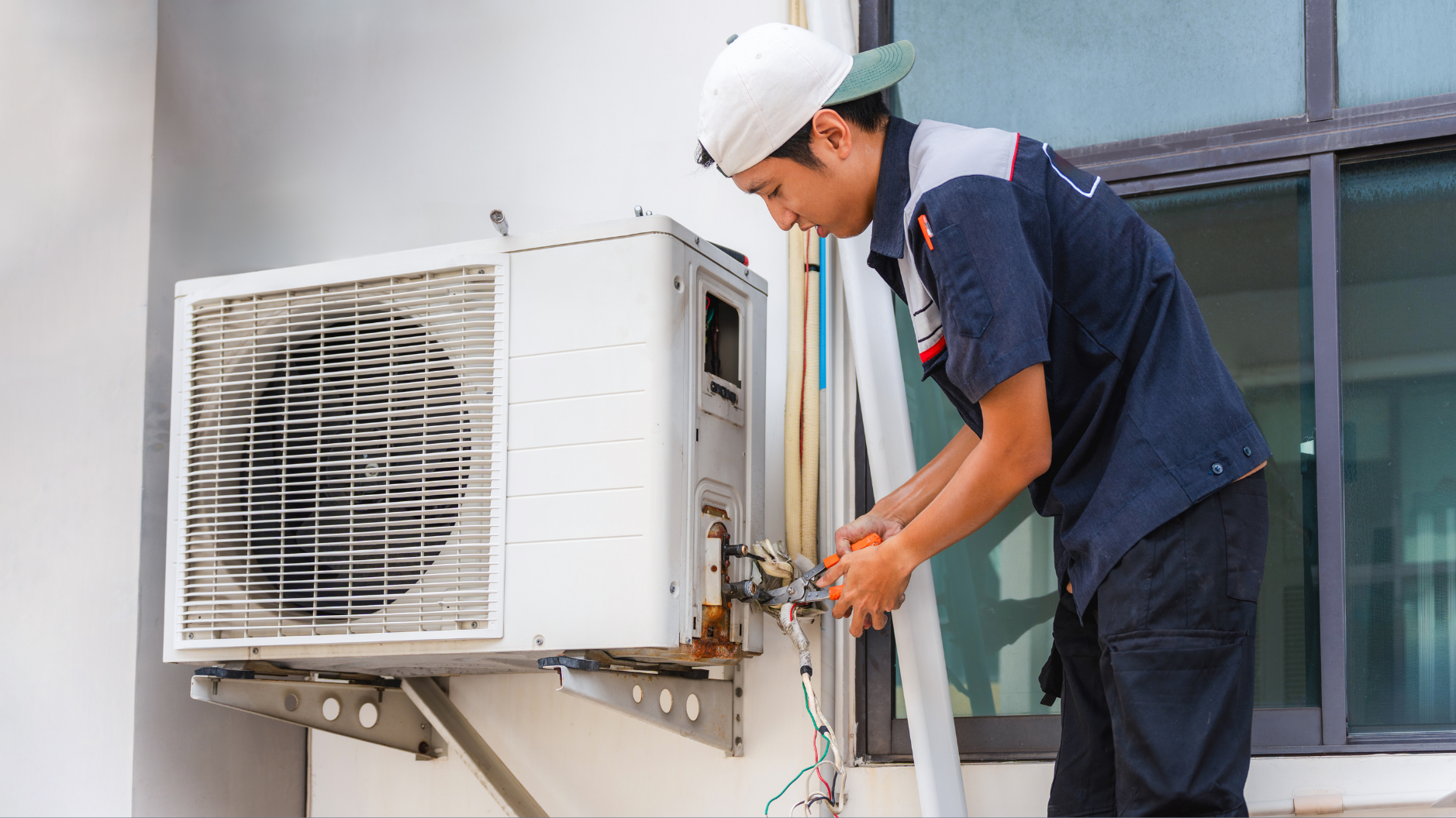 Technician repairing air conditioning unit