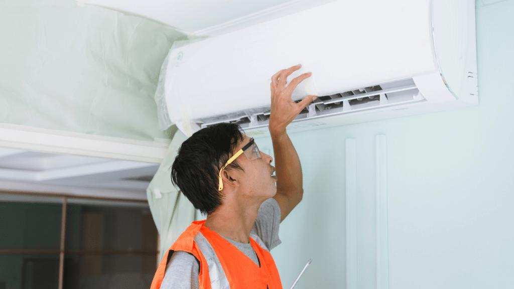 Technician installing air conditioning unit