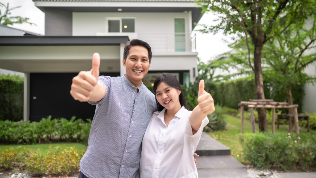 Happy couple giving thumbs up